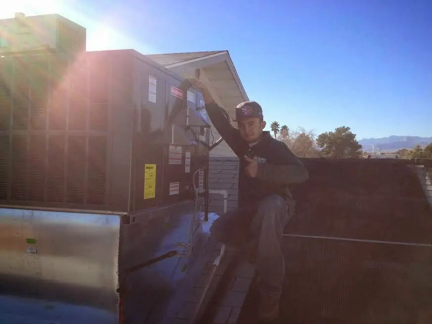 HVAC technician performing AC Tune-Up on a rooftop unit in McCandless